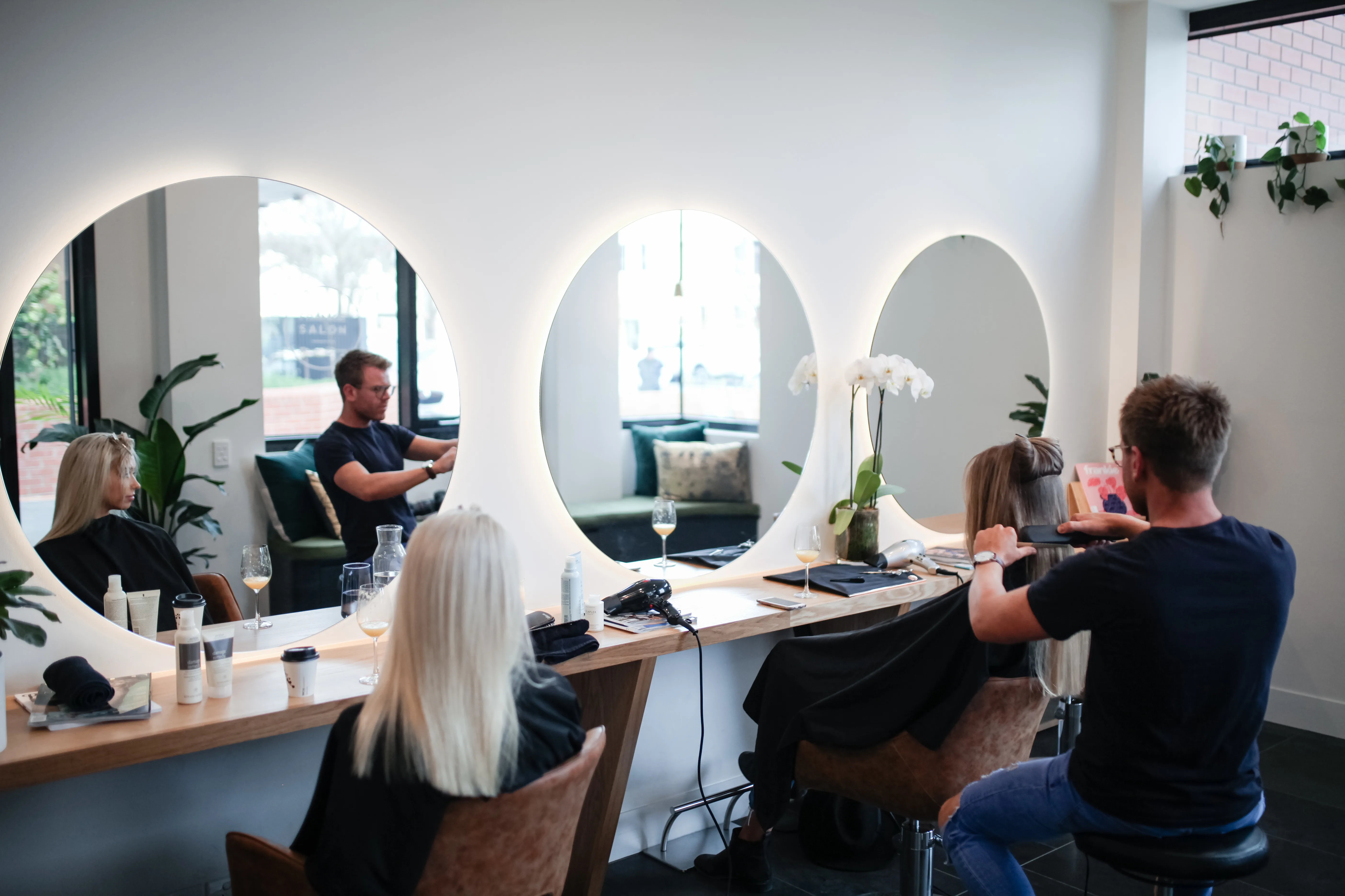 Frankie stylists at work along the circular mirror styling station