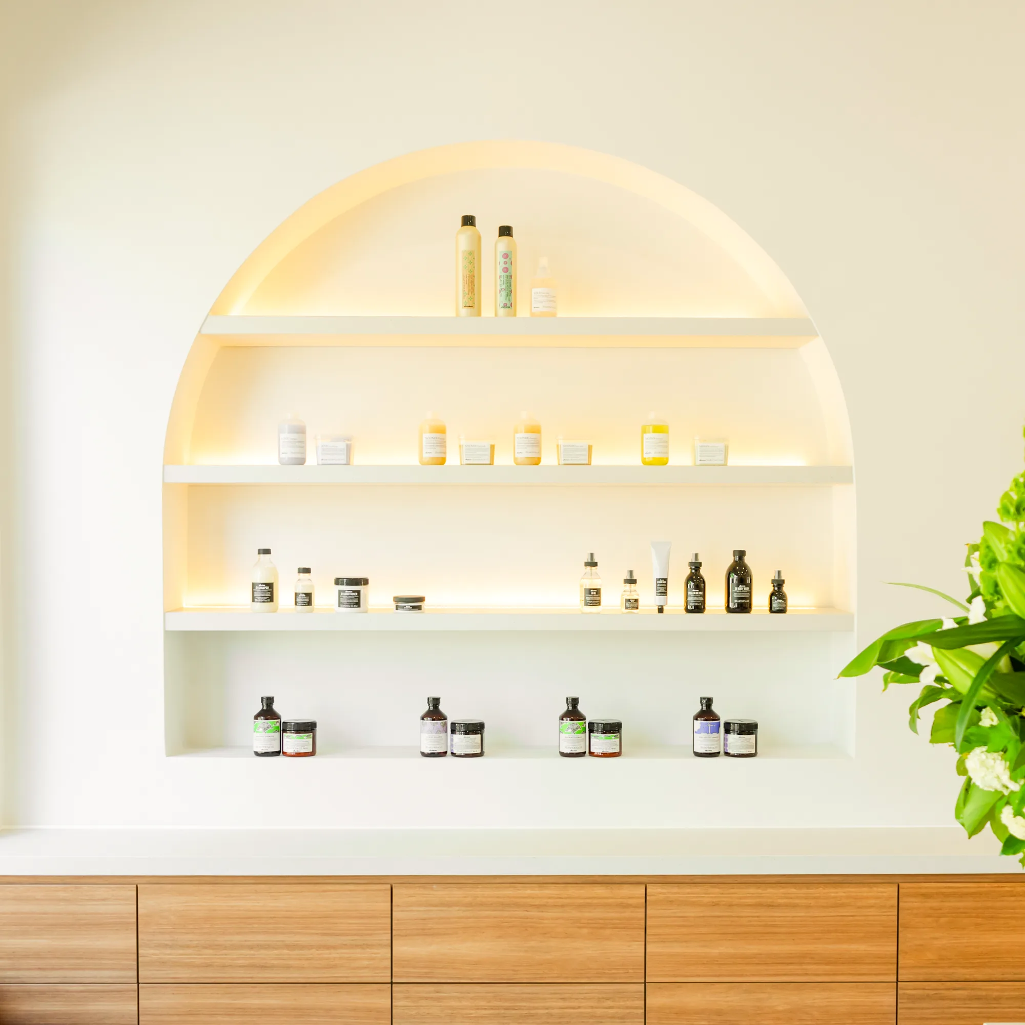 Frankie's curated retail niche with haircare products on white shelves