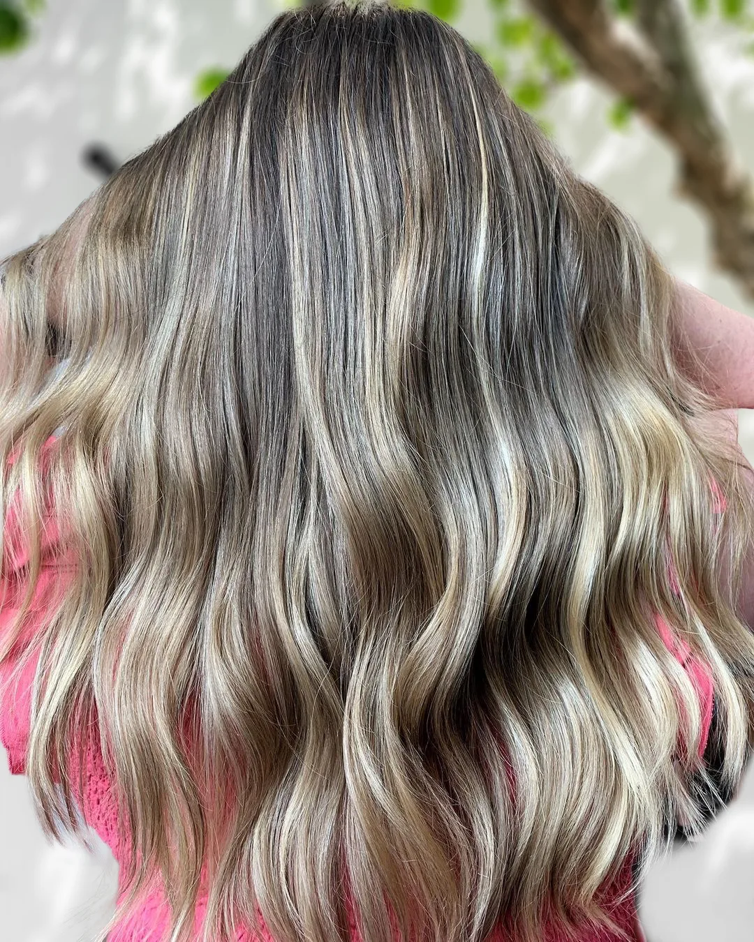 Brunette-to-blonde balayage waves result in dappled light